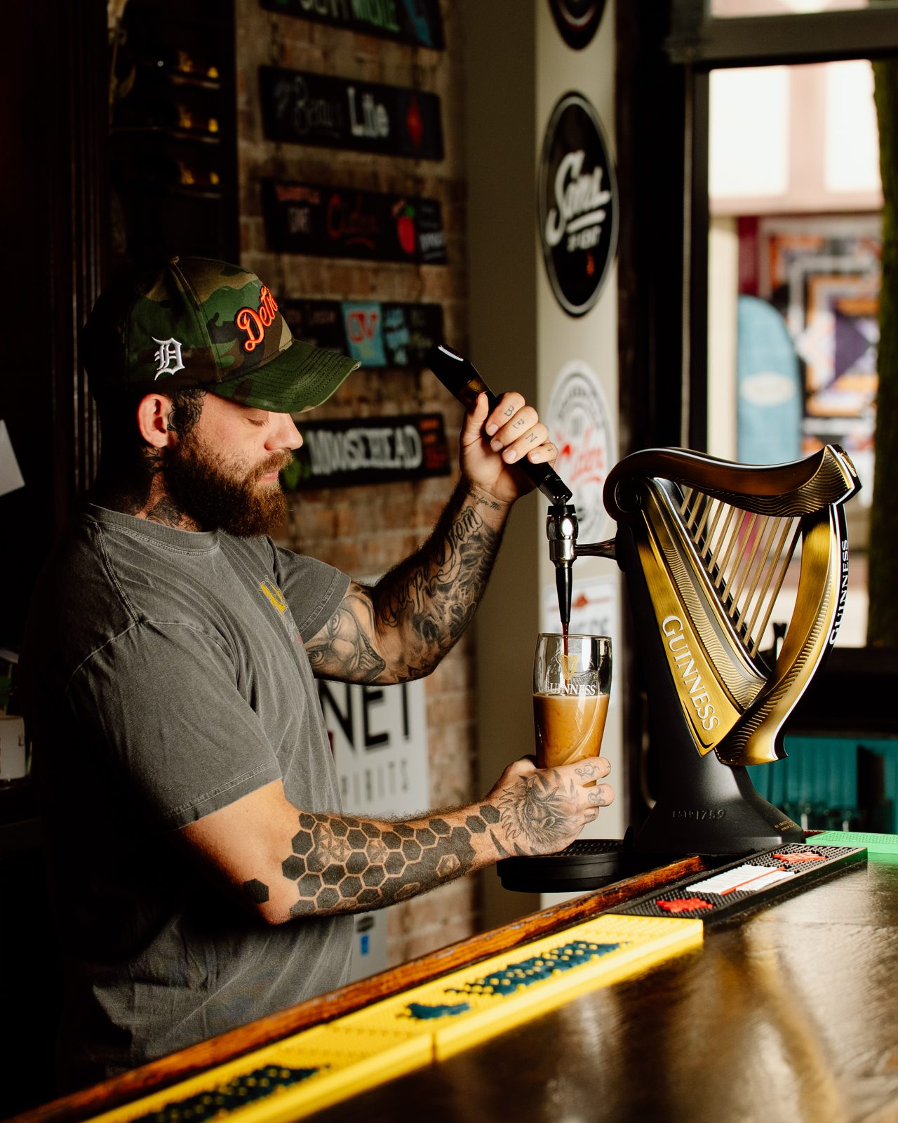 Crow City bartender pouring a pint of Guinness