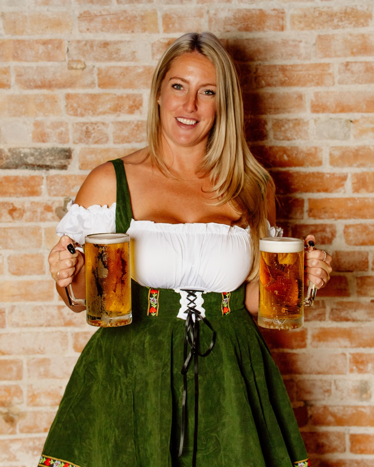 Server holding two beer steins